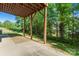 Exterior basement patio with beautiful wooded view offers an excellent outdoor space for entertaining guests at 1806 Red Bird Cir, Concord, NC 28025