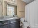 Bathroom with granite countertop vanity and toilet with shower and curtain at 1806 Red Bird Cir, Concord, NC 28025