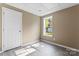 A neutral bedroom with wood-look flooring and a bright window view at 1806 Red Bird Cir, Concord, NC 28025