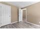 Bright bedroom features two closets, neutral paint and wood-look flooring at 1806 Red Bird Cir, Concord, NC 28025