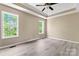 Comfortable bedroom featuring two windows providing natural light and light gray floors at 1806 Red Bird Cir, Concord, NC 28025