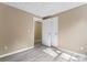 An open room with wood floors and a double-door closet for extra storage at 1806 Red Bird Cir, Concord, NC 28025