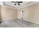 Bright bedroom boasts tray ceilings, ceiling fan, light gray floors and an ensuite bathroom for extra convenience at 1806 Red Bird Cir, Concord, NC 28025