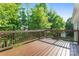 Wooden deck features a wooden railing and views of the wooded backyard, perfect for entertaining at 1806 Red Bird Cir, Concord, NC 28025