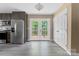 Dining area next to the kitchen with gray cabinets, stainless steel refrigerator, and French doors to the exterior at 1806 Red Bird Cir, Concord, NC 28025