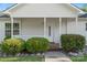 Charming front porch with white columns and manicured bushes that enhance the inviting entrance at 1806 Red Bird Cir, Concord, NC 28025