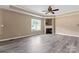 Living room with fireplace, and wood-look flooring with bright natural light at 1806 Red Bird Cir, Concord, NC 28025