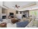 Open living room showcases a fireplace, ceiling fan, and seamless flow into the modern kitchen and dining area at 1806 Red Bird Cir, Concord, NC 28025