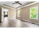 Bright bedroom with large windows allowing plenty of natural light and ceiling fan for added comfort at 1806 Red Bird Cir, Concord, NC 28025