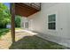 Spacious walkout basement area featuring an outdoor entrance, window, and concrete patio under a deck at 1806 Red Bird Cir, Concord, NC 28025