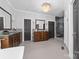 This elegant bathroom features dual sinks with wood cabinets and a luxurious glass enclosed shower with gray tile at 18920 Peninsula Club Dr, Cornelius, NC 28031