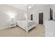 This bedroom features a four poster bed, bedside tables, neutral walls and carpet, with two doors at 18920 Peninsula Club Dr, Cornelius, NC 28031
