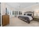 This bedroom is filled with natural light with a large bay window and neutral colors and textures at 18920 Peninsula Club Dr, Cornelius, NC 28031