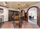 Modern dining area with tile flooring, wine storage, and arched doorway to another room at 18920 Peninsula Club Dr, Cornelius, NC 28031