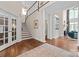 Elegant foyer with hardwood floors, staircase, columns, and access to the living room, creating a grand entrance at 18920 Peninsula Club Dr, Cornelius, NC 28031