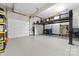Spacious garage with vehicle lift, storage cabinets, and ample room for multiple vehicles at 18920 Peninsula Club Dr, Cornelius, NC 28031