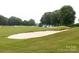 Golf course with lush green fairways, sand traps, and mature trees, offering a scenic view at 18920 Peninsula Club Dr, Cornelius, NC 28031