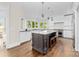 Beautiful kitchen with center island, pendant lights, stainless steel appliances, and a picturesque view from the windows at 18920 Peninsula Club Dr, Cornelius, NC 28031