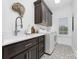 Well-lit laundry room offers modern fixtures, patterned floor, washer, and ample cabinet storage at 18920 Peninsula Club Dr, Cornelius, NC 28031