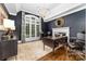 Sophisticated office with dark walls, hardwood floors, a large window, a chandelier, and a stylish desk at 18920 Peninsula Club Dr, Cornelius, NC 28031