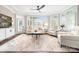 Inviting sunroom with large windows, plantation shutters, hardwood floors, and comfortable seating, offering natural light at 18920 Peninsula Club Dr, Cornelius, NC 28031