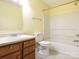 Bright bathroom featuring a combination tub and shower, tile floors, and wooden vanity at 2017 Beckwith Ln, Waxhaw, NC 28173