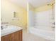 A bathroom with double sinks, tile floor, bathtub and a shower with a shower curtain at 2017 Beckwith Ln, Waxhaw, NC 28173