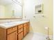 Bathroom featuring a double sink vanity with wooden cabinets and a large mirror at 2017 Beckwith Ln, Waxhaw, NC 28173