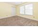 Bedroom with carpet and large window provides natural light at 2017 Beckwith Ln, Waxhaw, NC 28173