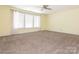 Expansive bedroom with neutral carpet, a ceiling fan, and a large picture window at 2017 Beckwith Ln, Waxhaw, NC 28173