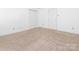 Cozy bedroom with neutral carpet, white walls, and two access doors at 2017 Beckwith Ln, Waxhaw, NC 28173
