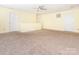 Spacious bedroom featuring neutral carpet, ceiling fan, and multiple doors at 2017 Beckwith Ln, Waxhaw, NC 28173