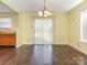 Dining area featuring wood floors and sliding door access to the backyard and connecting to the kitchen at 2017 Beckwith Ln, Waxhaw, NC 28173