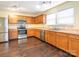 Well-lit kitchen with stainless steel appliances, wood cabinets, and laminate countertops at 2017 Beckwith Ln, Waxhaw, NC 28173