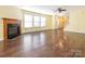 Bright living room with hardwood floors, a fireplace, and large windows for natural light at 2017 Beckwith Ln, Waxhaw, NC 28173