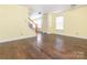 Living room featuring hardwood floors, light yellow walls, a staircase, and a closet at 2017 Beckwith Ln, Waxhaw, NC 28173