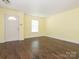 Spacious living room featuring a large window, light yellow walls and hardwood floors at 2017 Beckwith Ln, Waxhaw, NC 28173