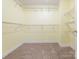 Empty walk-in closet with carpeted floor and wire shelving for storage at 2017 Beckwith Ln, Waxhaw, NC 28173