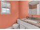 Bathroom featuring a granite countertop, framed mirror, and window at 2126 Downing St, Charlotte, NC 28205