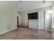 Light-filled bedroom featuring a TV and doors to other rooms at 2126 Downing St, Charlotte, NC 28205