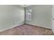 A simple bedroom with carpet, natural light and neutral wall color at 2126 Downing St, Charlotte, NC 28205