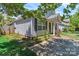 Side view of a single-Gathering home with a neatly landscaped yard and blooming flowers at 2126 Downing St, Charlotte, NC 28205
