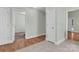 Hallway offers views into rooms with hardwood and tile flooring at 2126 Downing St, Charlotte, NC 28205