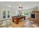 Finished basement with pool table, stone fireplace, and lots of light at 221 Grayrock Dr, Statesville, NC 28677