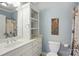 Bathroom with white cabinets, marble counter tops, a large mirror, and bright coastal decor at 221 Grayrock Dr, Statesville, NC 28677