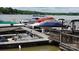 Dock with covered boats and jet skis, offering convenient access to lake activities at 221 Grayrock Dr, Statesville, NC 28677