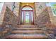Close-up of the home's brick entrance with a decorative door and welcoming ambiance, featuring a brick facade at 221 Grayrock Dr, Statesville, NC 28677