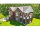 Aerial view of a brick house with a deck, showcasing its architectural design and well-kept outdoor space at 221 Grayrock Dr, Statesville, NC 28677