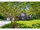 Beautiful brick home with a well-maintained lawn and lush greenery creating a private and inviting atmosphere at 221 Grayrock Dr, Statesville, NC 28677