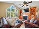 Bright living room featuring a fireplace, large arched window, built-in shelving, and cozy seating for relaxation at 221 Grayrock Dr, Statesville, NC 28677